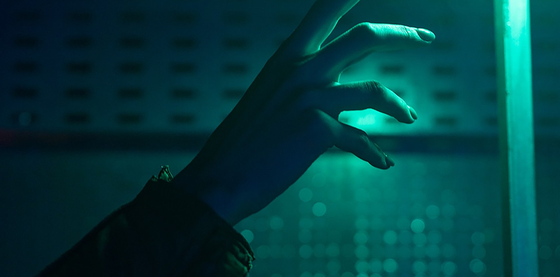 Hand with a background of turquoise light