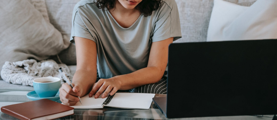 Person typing on computer while looking at computer