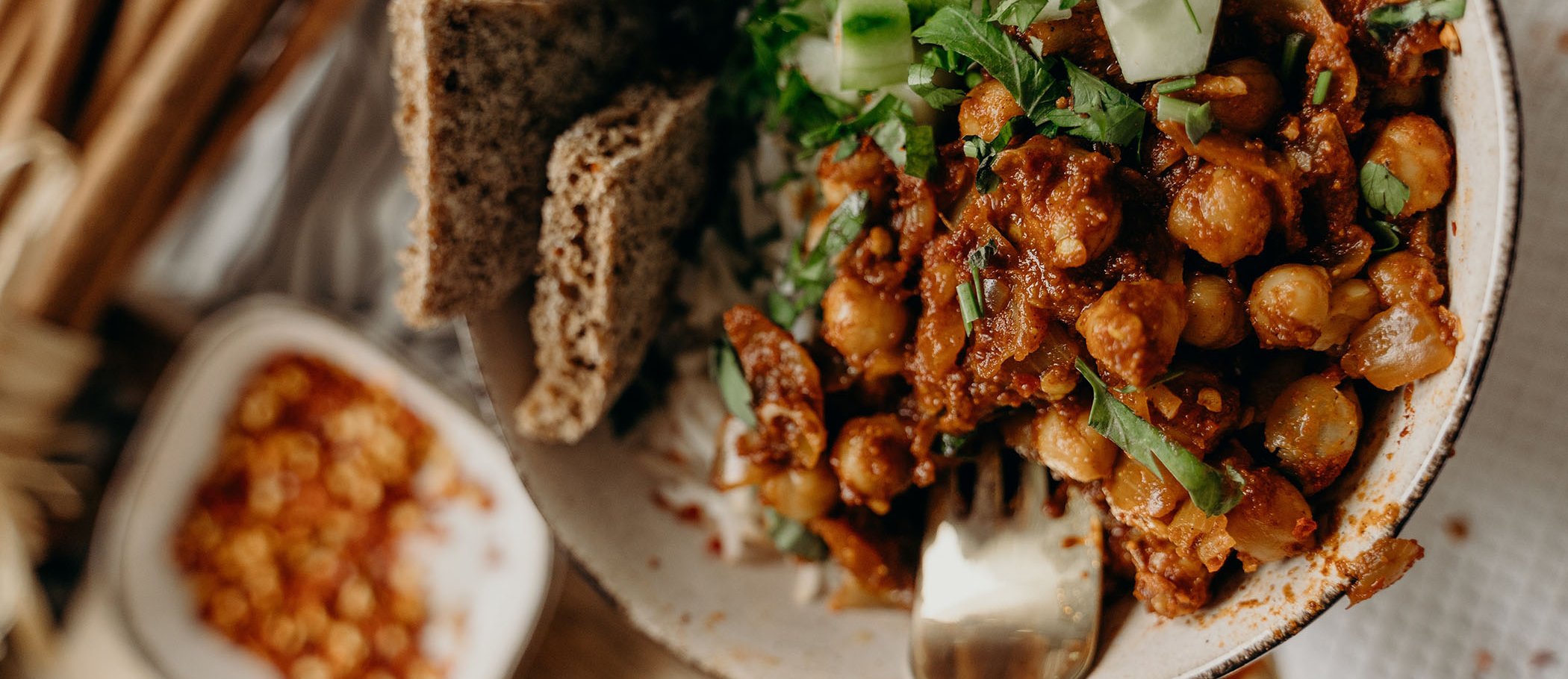 A fork inside a plate made with chickpeas