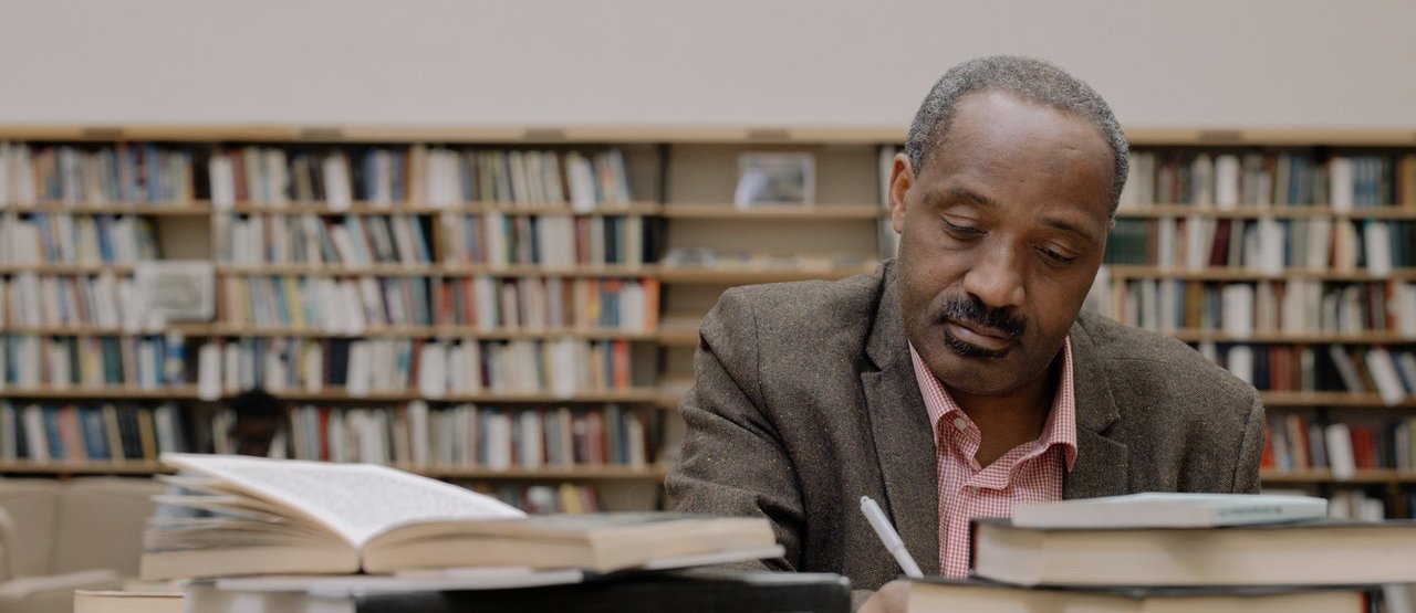 Man sitting reading books