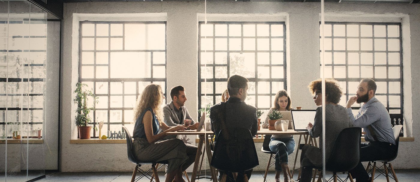 A group of people talking at a meeting