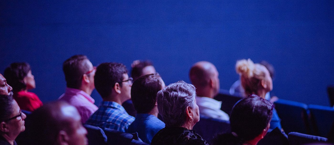 Several attendees at a congress seated in armchairs