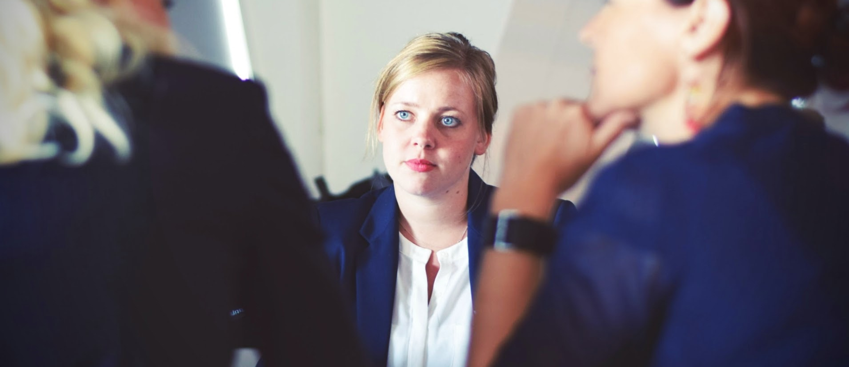 A woman in an office talking to her colleagues