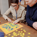 Two people playing the scrabble game