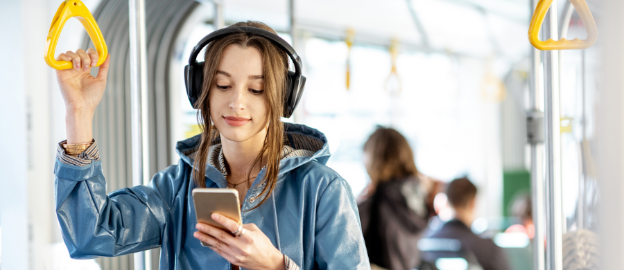 A girl consulting the mobile in public transport