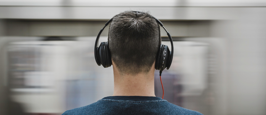 A boy with headphones in the subway