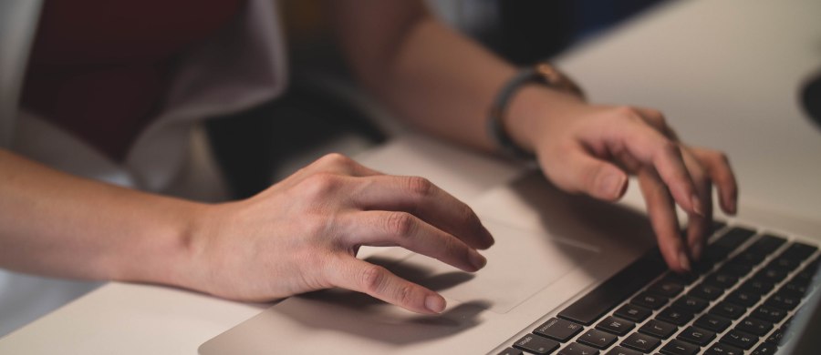 Person typing on computer keyboard