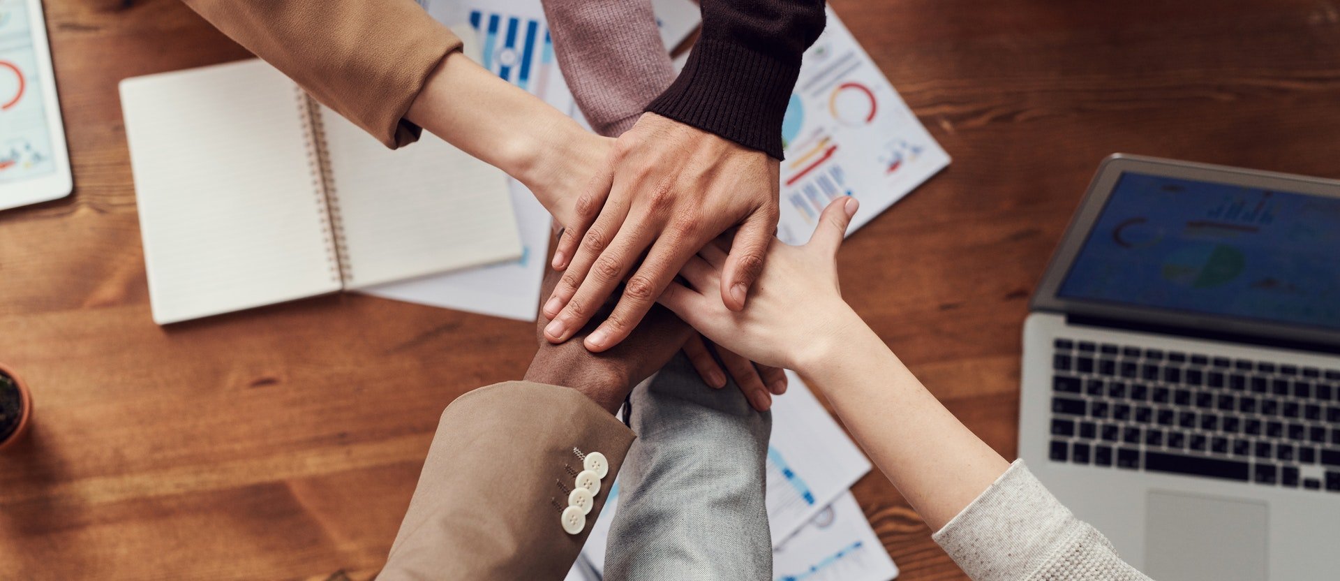 A mountain of hands making team building