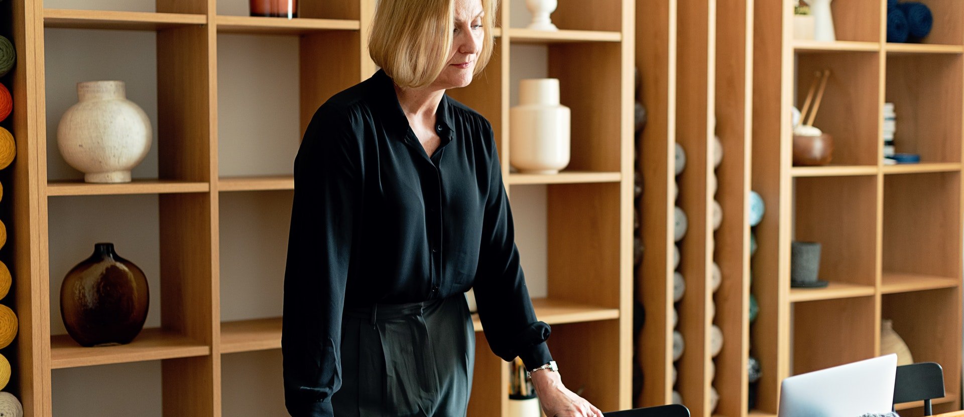 Woman about to sit in front of a computer