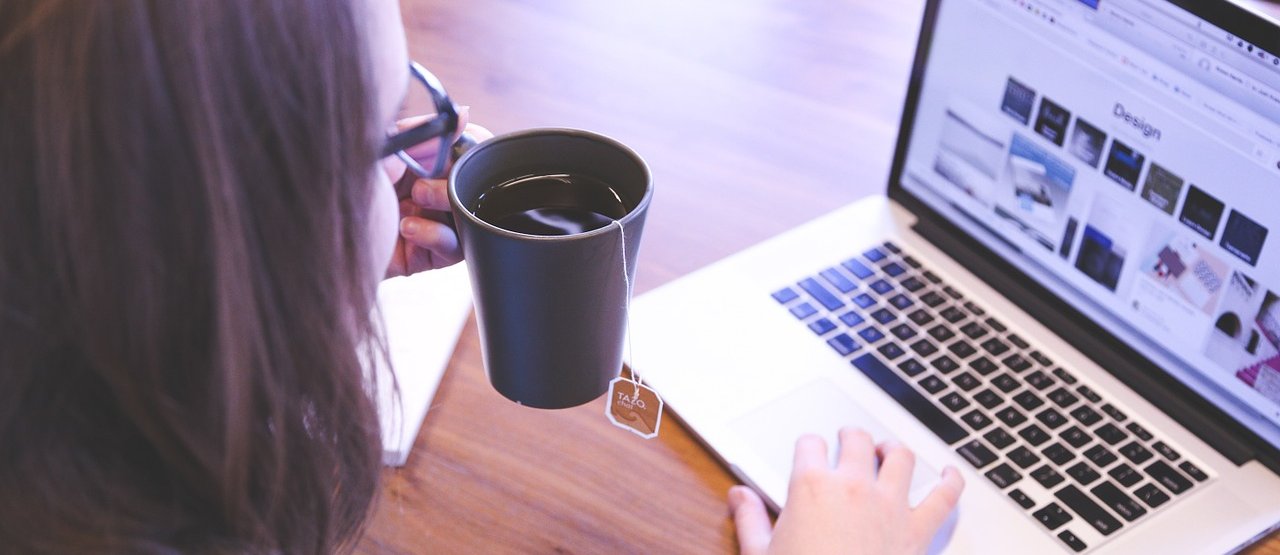 Woman learning online with a cup of tea