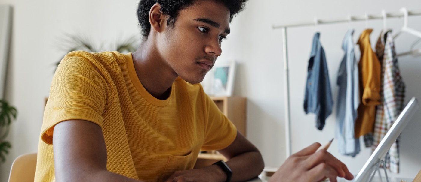 A boy with a pen and a tablet 