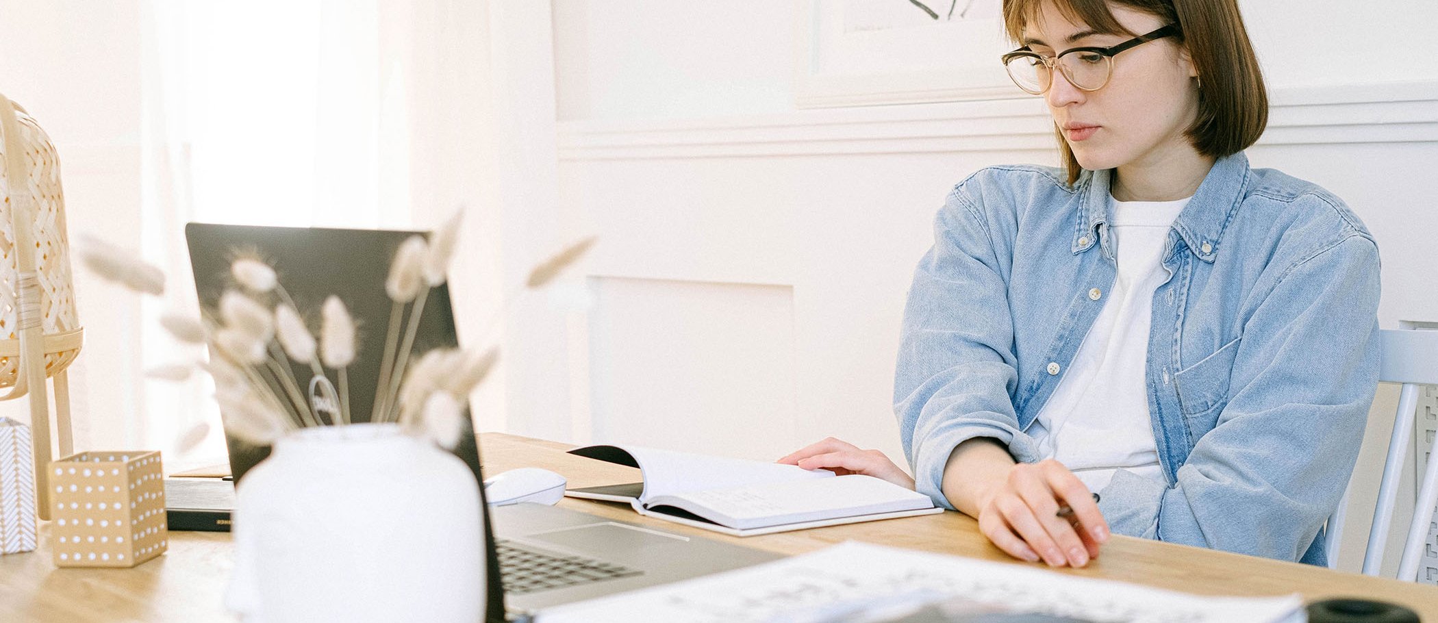 A girl writing on a laptop