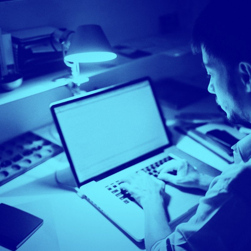 A man writing on a laptop