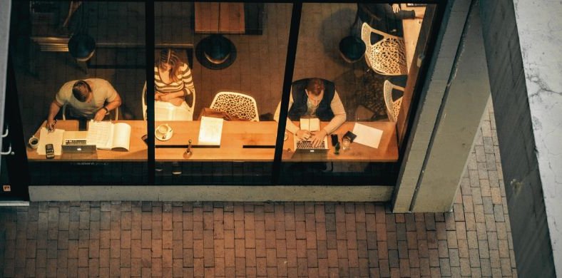 A group of people studying in the cafeteria