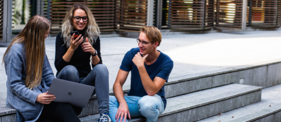 A group of people talking sitting on the stairs